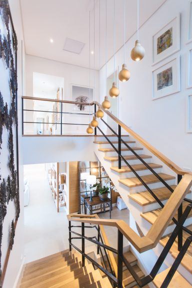 Open timber and steel staircase leading to a loft conversion